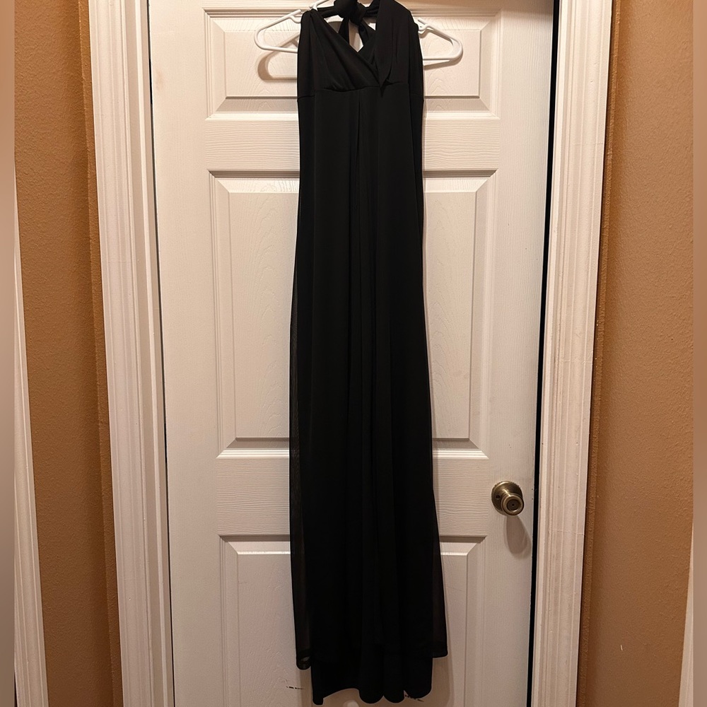 Used Blk Jumper with sheer skirt and open back. Size medium.